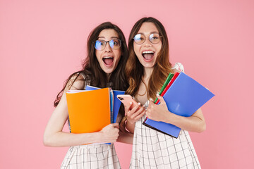 Wall Mural - Image of student women holding exercise books and using cellphone