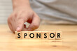 Sponsor writing on wooden cube blocks, word text typography arrange on wood table