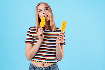 Canvas Print - Image of cheerful pretty girl eating ice-cream and smiling