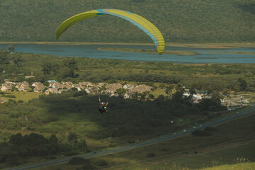 Paraglider are flying in the sky over the fields