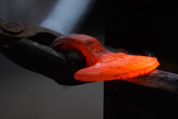 Forging the molten metal, making of an axe, traditional smithy