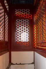 Wall Mural - Red wooden window and decoration colorful painting wall from ancient china palace in forbidden City, Beijing, China