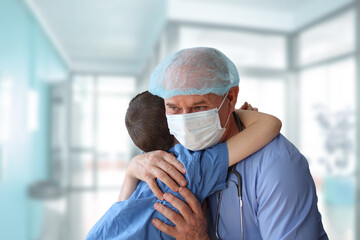 little patient is hugged by a male doctor, therapist, pediatrician, concept of medical treatment, in