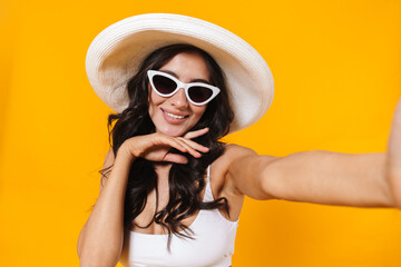 Sticker - Image of cheerful woman smiling while taking selfie photo