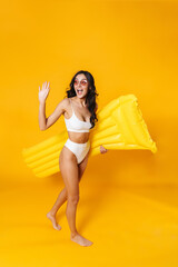 Poster - Image of excited woman posing with air mattress and waving hand