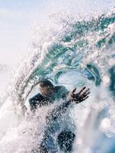 Surfer Caught Inside The Lip Of A Wave