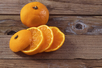 On a wooden background lie two fresh and ripe tangerines