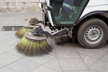    Cleaning the streets of the city with the help of a special machine with rotating brushes.