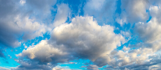 Bright volumetric curly clouds on a blue sky