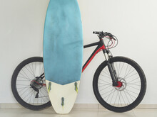Mountain Bike And Surfboard At Home. Lifestyles.