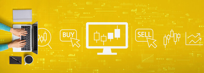 Stock trading theme with person using a laptop computer