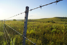 A Barbed Wire Fence Separates Ranch Properties In The Flint Hills Of Rural Kansas.