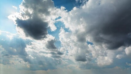 Wall Mural - amazing timelapse of white fluffy clouds moving across the sky in bright sunshine. beautiful sun ray