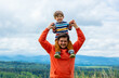 © Masson - Father with son walking at outdoor with mountains on background