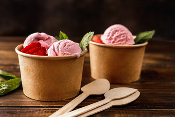 Wall Mural - Close up of strawberry ice cream in eco craft paper cups