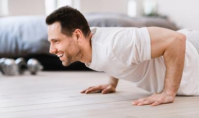 Aufkleber - Happy Man Doing Plank Exercise Training Indoors On Weekend Morning