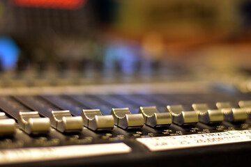 Closeup Analog sound mixer with selected focus. Professional audio mixing console broadcasting.