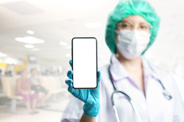 Doctor in uniform holding smart phone with blank white screen for text on blur background. Coronavirus, covid-19  outbreak concept.