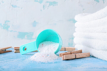 Sticker - Laundry detergent with towels and pegs on color background