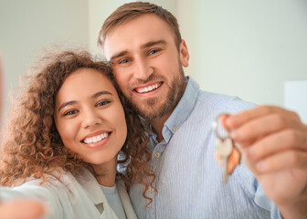 Wall Mural - Happy young couple with key in their new flat