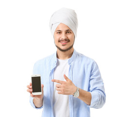 Wall Mural - Handsome young Indian man with mobile phone on white background