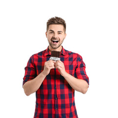 Wall Mural - Handsome young man with tasty chocolate on white background