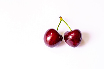 The layout of two ripe red cherries with copy space