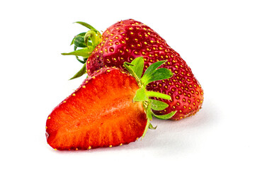 strawberries on the white background one strawberry whole another cut in half