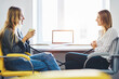 © BullRun - Women coworkers sitting in coworking office near computer with mock up screen