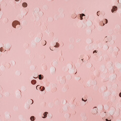 Wall Mural - Pink celebration background with holiday sparkling confetti. Flat lay, top view