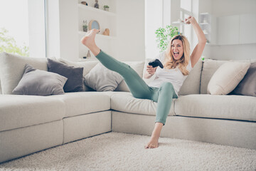 Sticker - Photo of beautiful cheerful funny lady sit comfy couch raise fist leg positive emotions playing video games stay home quarantine excited addicted gamer winner victory living room indoors