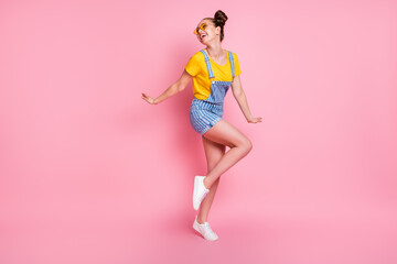 Full length body size view of her she nice attractive pretty cheerful cheery dreamy brown-haired teen girl posing dancing having fun isolated over pink pastel color background