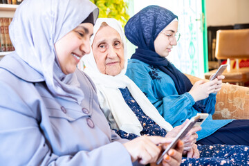 Wall Mural - Happy arabic muslim grandmother and grand daughter and mother si