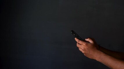 busy using smartphone with dark background and a copyspace