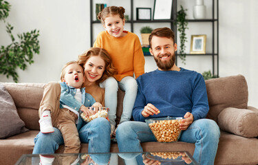 Wall Mural - Joyful family resting on sofa together.