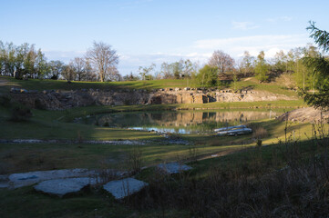 Wall Mural - Some canoes parked in front of a pond in an old stone quarry in the hiking area of Skrylle in Skåne (Scania) in southern Sweden