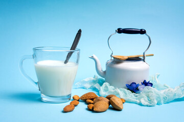 Wall Mural - Almond Milk in a Glass on blue background