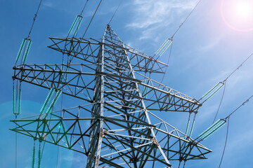 Electricity transmission pylon on blue sky background. High voltage post or high voltage tower. Concept of electricity and energy.