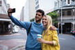© Wavebreak Media - Caucasian couple on the go in the city taking selfie