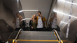 © Wavebreak Media - Caucasian couple on the go taking the escalator