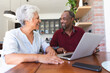© Wavebreak Media - Senior African American couple using laptop