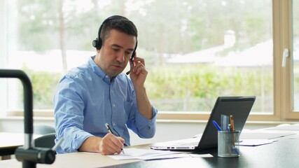 Wall Mural - remote job, technology and business concept - middle-aged man with headset and laptop computer having conference call at home office