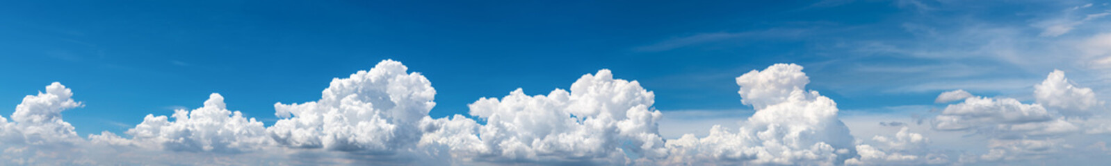 White fluffy clouds on blue sky. Soft touch feeling like cotton. White puffy clouds cape with space for text. Beauty in nature. Close-up white cumulus clouds texture background. Sky on sunny day.