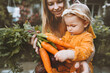© EVERST - Mother and child daughter with organic vegetables healthy food family lifestyle homegrown beet and carrot local farming gardening vegan nutrition concept