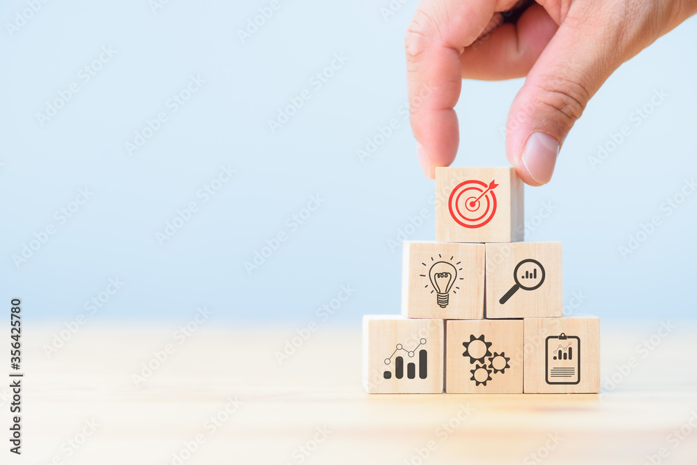 Business development strategy and action plan concept. hand arranging wood block with icon business strategy and Action plan. - obrazy, fototapety, plakaty 