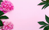 Fototapeta Tulipany - Composition of pink peonies, leaves on the left side and only leaves on the right. Fresh flowers on a pink background. Floral banner for Birthday, Valentines Day, Womens day. Top view, copy space