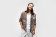 © Marharyta Hanhalo - Smiling friendly fun guy, attractive and kind hippie. Hipster traveler stylish carefree man on a white studio background, people lifestyle