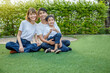 © Thannaree - Happy asian family father mother and son sitting and play at home garden. Good mood moment time.