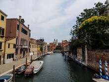 Canal Waterway, Bridge And House With Tree In Venice Italy