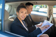 © zinkevych - Smiling woman with papers man with laptop in car